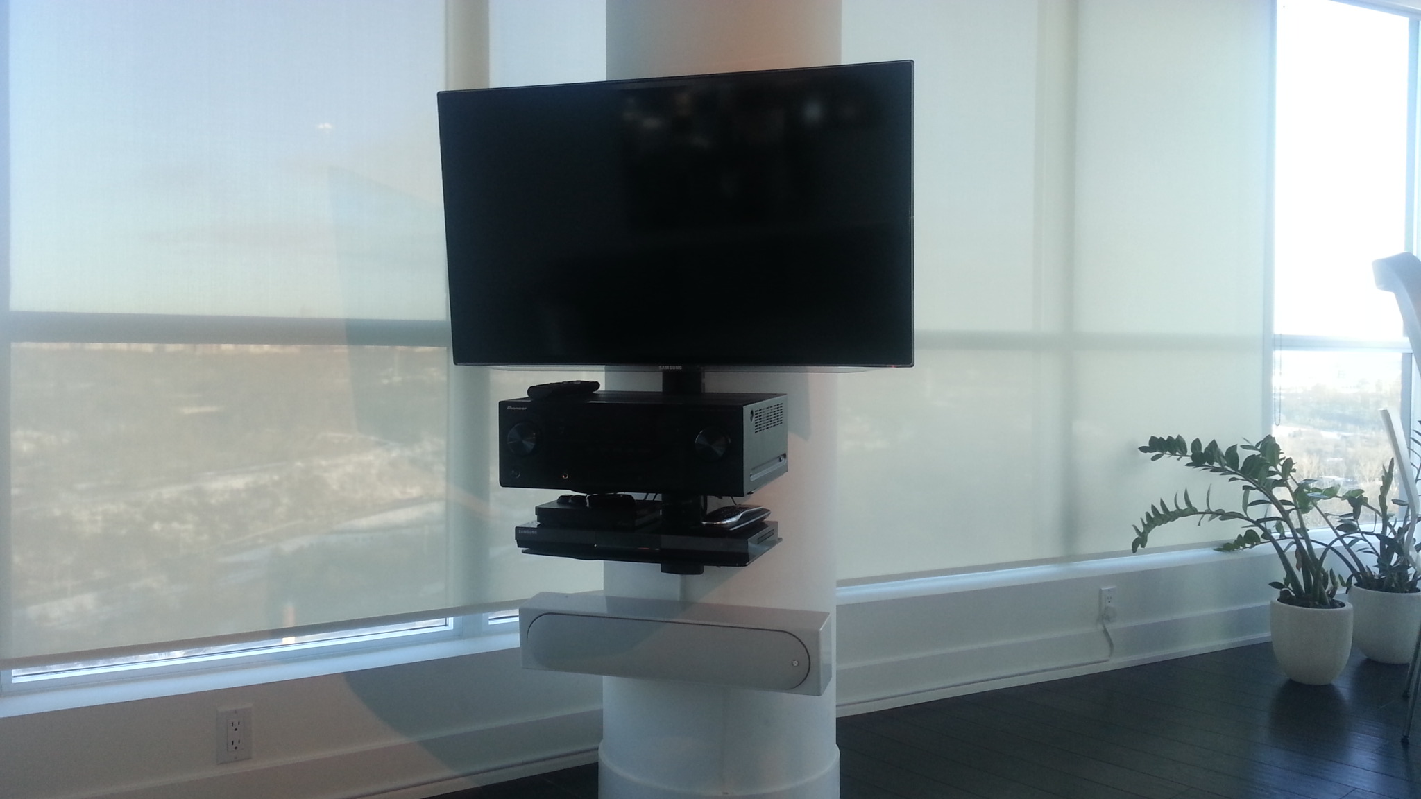 Sound bar on circular concrete pillar bottom of tv ... house wiring for tv and data 